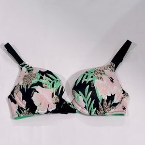 A Victoria Secret Bra , color green , black and pink .
